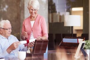 elderly couple at table with with last will and testament gift