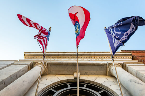 law firm building white marble facade with three flags