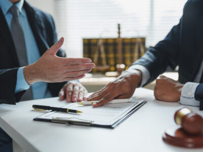 Two lawyers are discussing arbitration details during a meeting in a law office